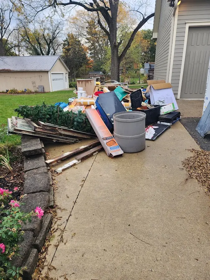 Dumpster being loaded with debris for Estate Cleanout Dumpster Rental in Harborcreek